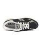 Black New Balance men's Abzorb 2010 sneakers with padded collar and white sole, designed for comfort and support.