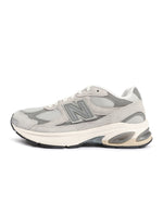 Grey New Balance Mens Abzorb 2010 footwear with cushioned sole and athletic design, displayed on a plain background.