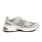Men's New Balance Abzorb 2010 grey athletic shoes with mesh and synthetic overlays, featuring cushioned midsoles for comfort.