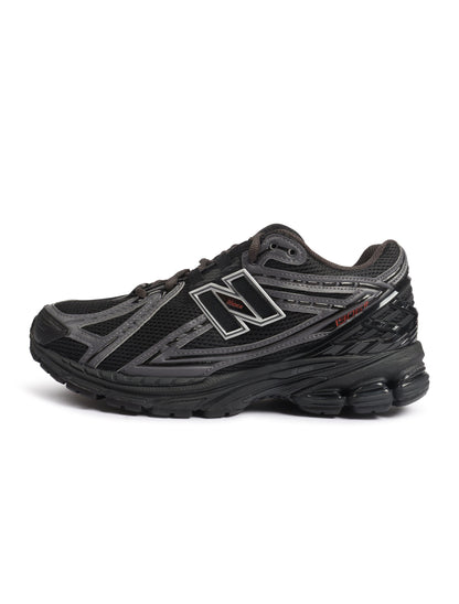 Men's New Balance 1906 black and hot tomato athletic footwear with white accents, showcasing the stylish design and comfortable fit.