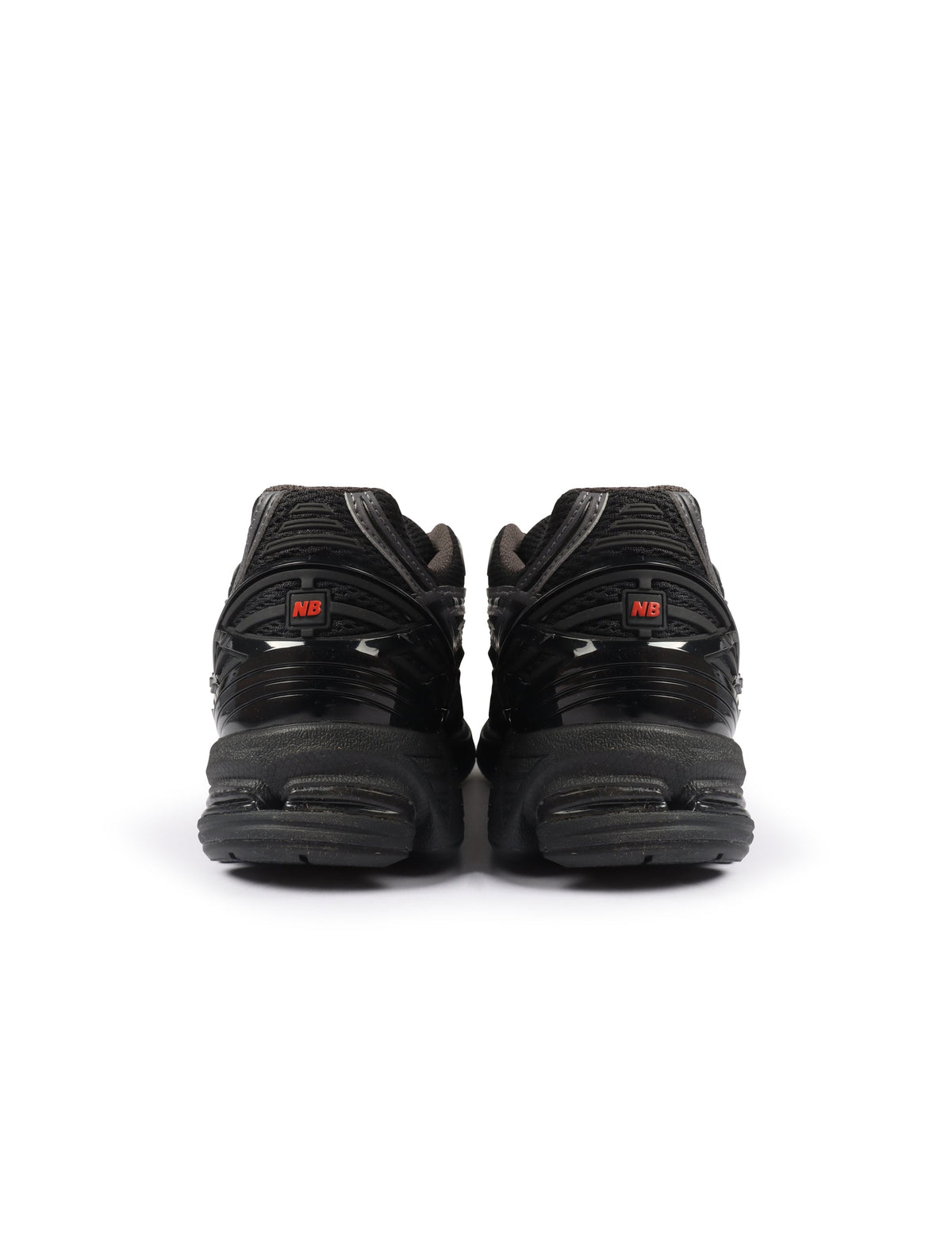 Men's New Balance 1906 sneakers in black and hot tomato colorway, showcasing stylish men's footwear with athletic design.