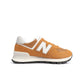 Brown and white New Balance men's 574 sneakers with suede and mesh upper, casual athletic footwear for everyday wear