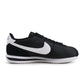Black and white Nike men's Cortez TXT sneakers by Denim Exchange, side view