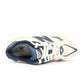 New Balance men's 9060 lifestyle shoes in cream and navy color, featuring stylish design and comfortable footwear for men.