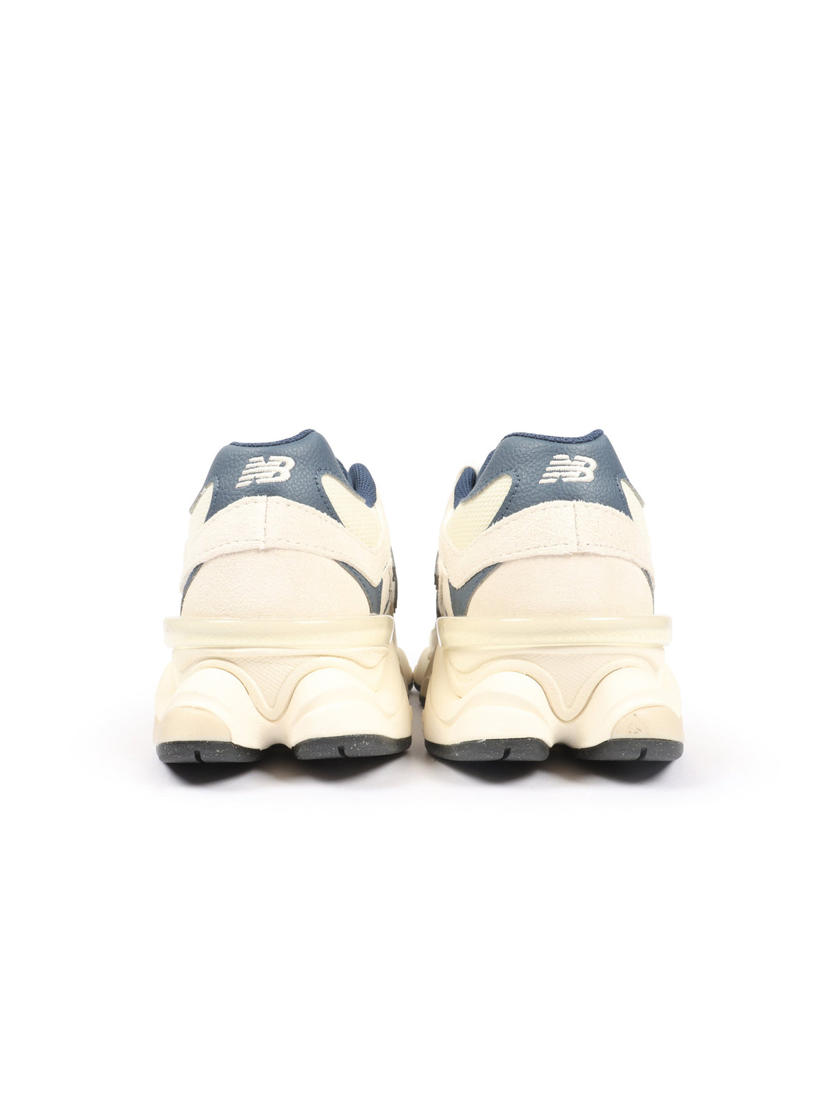 New Balance men's 9060 lifestyle shoes in cream and navy with white accents, showcasing stylish and comfortable footwear.