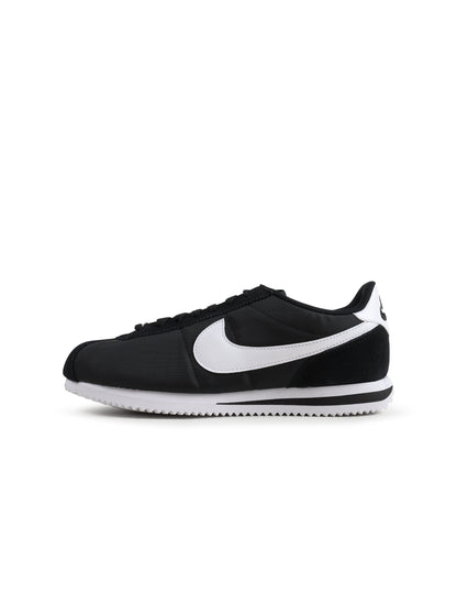 Nike Women's Cortez sneakers in black and white, stylish athletic footwear with classic design and white laces.