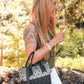 Small woven Tin Marin black crossbody bag with adjustable strap, featuring a compact design and textured fabric for everyday use.