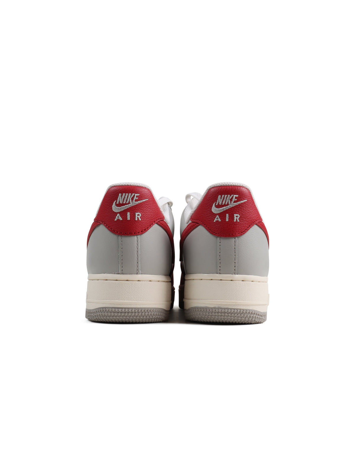 Red toe Nike Air Force 1 '07 LV8 men's footwear showing white leather sneakers with red accents and Nike branding.
