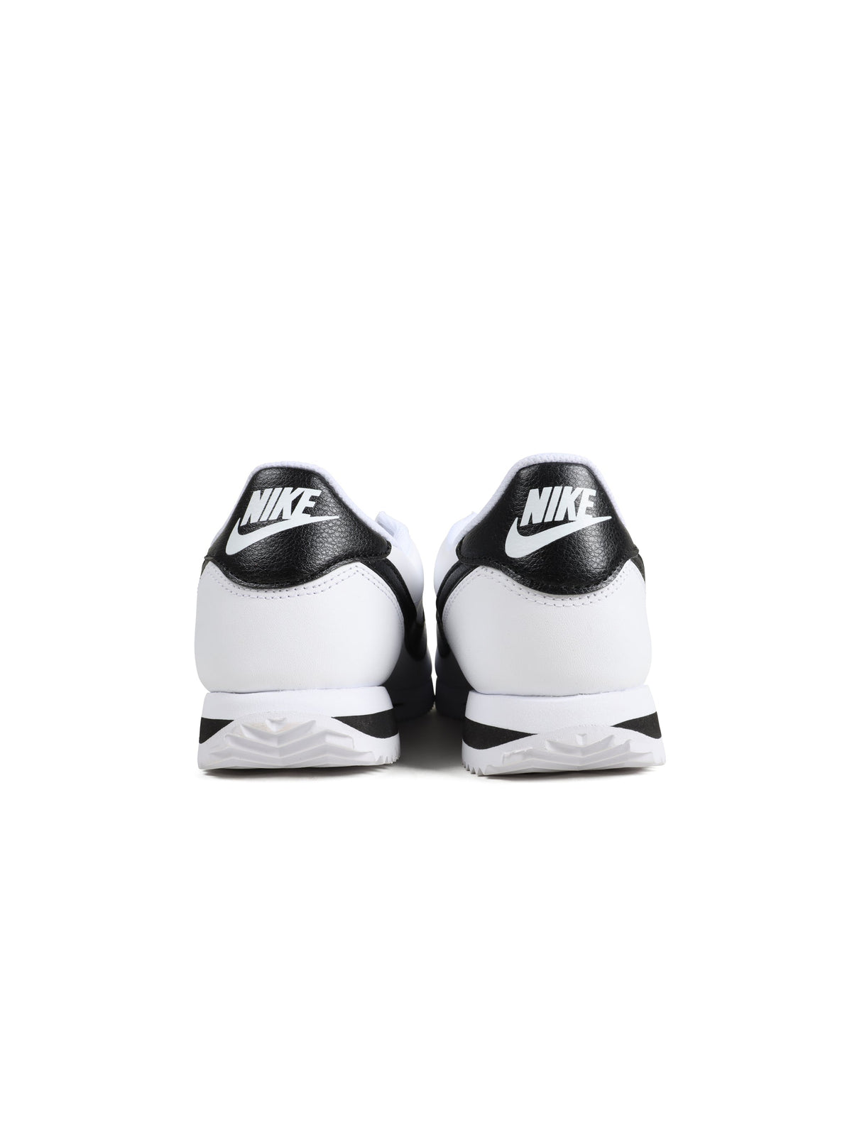 White and black Nike men's Cortez sneakers by Denim Exchange 马会