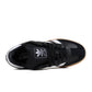 Black Adidas Mens Samba XLG footwear shown on a model, featuring classic design and durable leather construction.