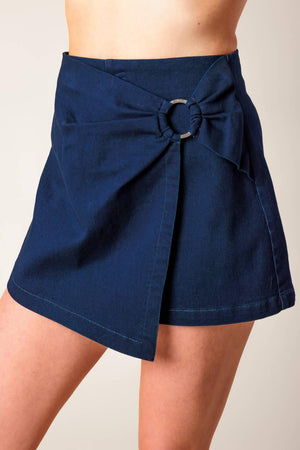 Flying Tomato denim woven skort in medium indigo, showcasing a stylish casual shorts design with a front button and pockets.