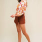 Rust-colored Flying Tomato twill skort with front pockets and a relaxed fit, designed as a stylish pair of shorts.