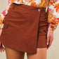 Rust-colored Flying Tomato twill skort, casual shorts with a structured design, featuring a front button and side pockets.