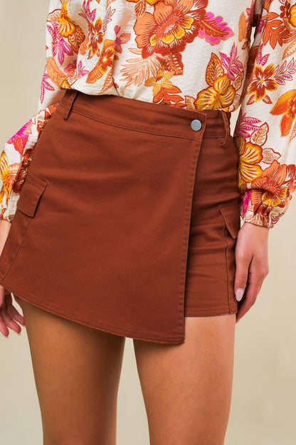 Rust-colored Flying Tomato twill skort, casual shorts with a structured design, featuring a front button and side pockets.