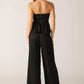 Black Elegant Essence woven pants by Flying Tomato, showcasing a stylish and comfortable design with intricate weaving details.