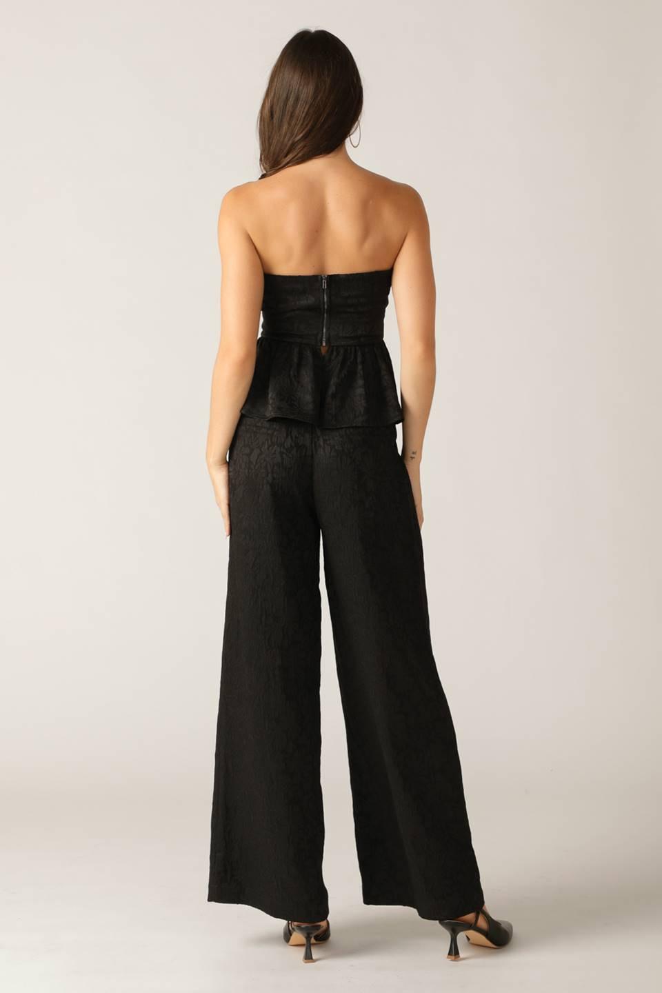 Black Elegant Essence woven pants by Flying Tomato, showcasing a stylish and comfortable design with intricate weaving details.