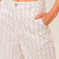 Flying Tomato Citrus Flow Ivory woven pants, lightweight and stylish with a relaxed fit, shown on a model.