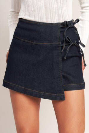 Dark indigo Flying Tomato denim skorts, weekend-ready casual style with a relaxed fit and front pockets, shown on a model.