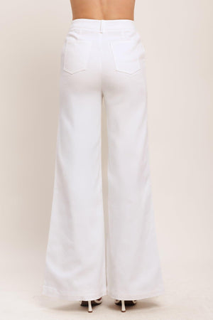 Flying Tomato Open Road white woven pants, casual denim-style pants with a relaxed fit and woven fabric, shown on a model.
