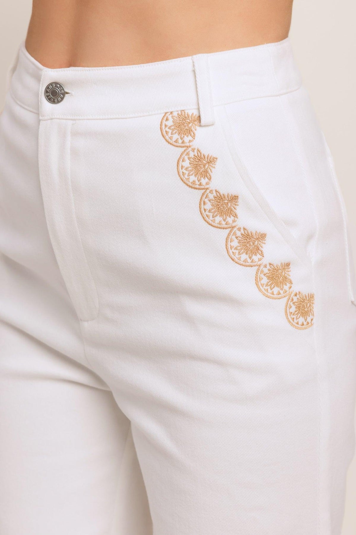 Flying Tomato open road white woven pants with a relaxed fit and denim texture, displayed on a hanger.