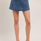 Flying Tomato Heart Eyes Denim Skort shorts in medium indigo with heart graphic and side pockets, casual and stylish for warm weather.