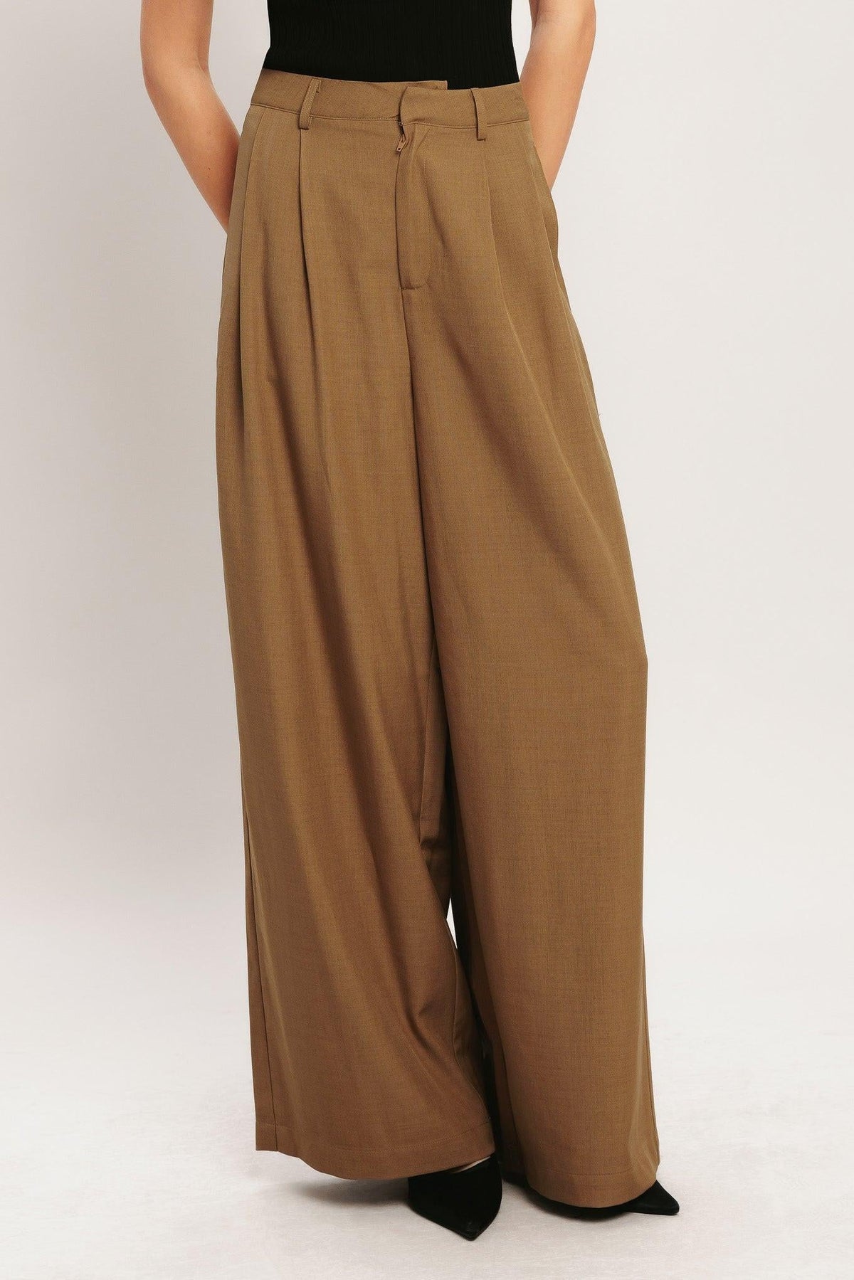 Flying Tomato Umber Flow woven wide-leg pants in brick color, showing the relaxed fit and textured fabric.