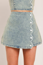 Flying Tomato Sweet Detail Denim Skort showing front view with layered denim design and asymmetrical hem detail.