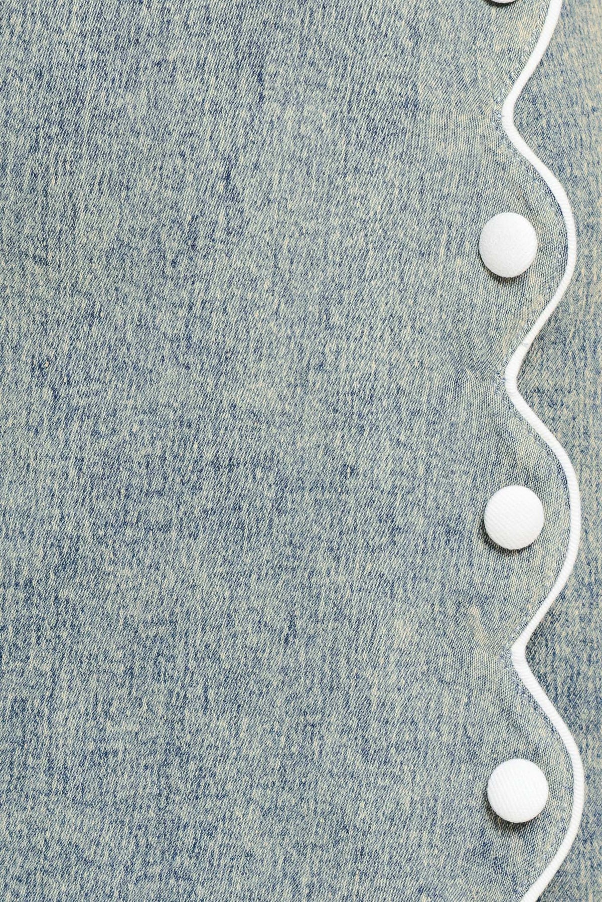 Flying Tomato Sweet Detail Denim Skort showing light wash denim fabric with front and back pockets and a button closure.