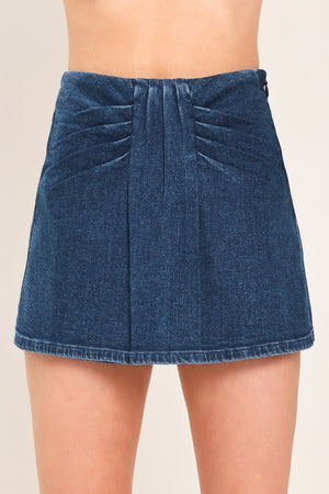 Flying Tomato indigo ruching denim skort with front pockets and adjustable waistband, styled on a model.