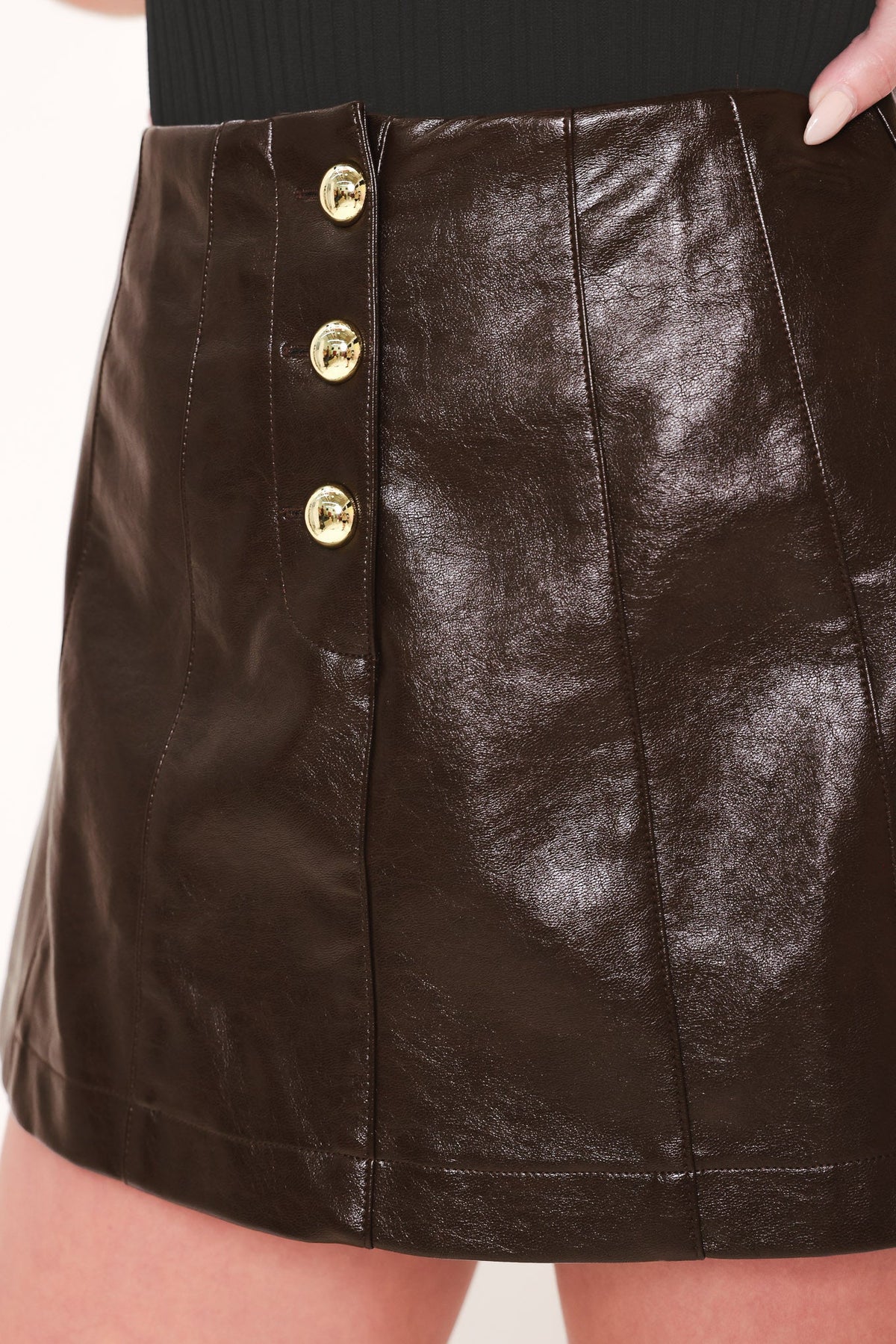 Dark brown faux leather skort from Flying Tomato with a lacquered finish, featuring a high-waisted design and side pockets.