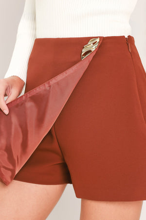 Rust-colored Flying Tomato spiced horizon Tencel side-zip skort, showing the front view with side zipper and smooth fabric.