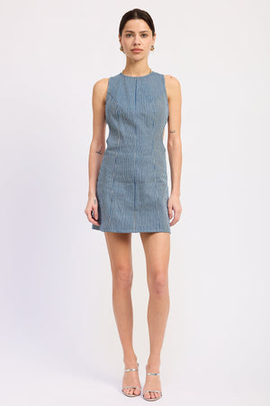 Emory Park Mabel Mini Dress in blue denim, shown on a model, with a fitted silhouette and sleeveless design.