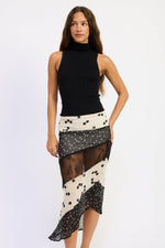 Emory Park Abby Maxi Skirt in black and ivory polka dot fabric, flowing design with a high waist and ankle-length silhouette.
