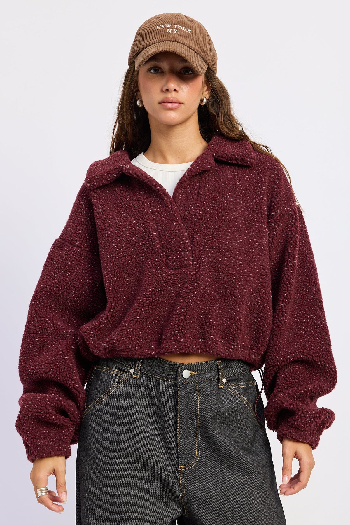 Emory Park Luella sweater in burgundy, soft knit fabric, with a relaxed fit and ribbed cuffs, displayed on a hanger.