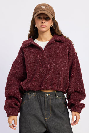 Emory Park Luella sweater in burgundy, soft knit fabric, with a relaxed fit and ribbed cuffs, displayed on a hanger.