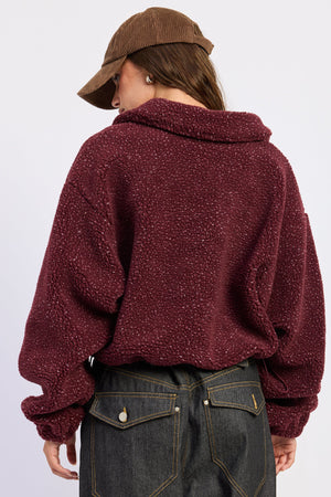 Emory Park Luella sweater in burgundy, cozy knit sweater with a classic fit and ribbed cuffs, displayed on a neutral background.