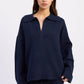 Navy blue Emory Park Aramelle oversized sweater with a cozy, relaxed fit, displayed on a hanger against a neutral background.
