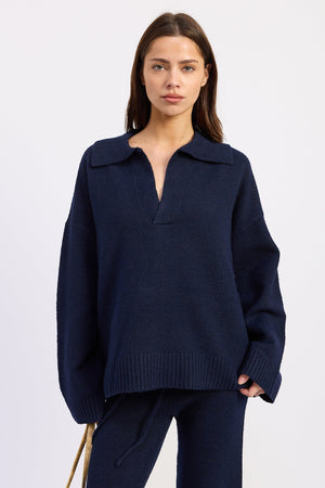 Navy blue Emory Park Aramelle oversized sweater with a cozy, relaxed fit, displayed on a hanger against a neutral background.