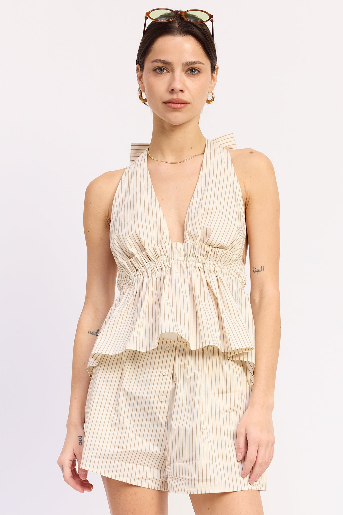 Cream and mocha striped Alivia halter top by Emory Park, featuring a stylish halter neckline and lightweight fabric.