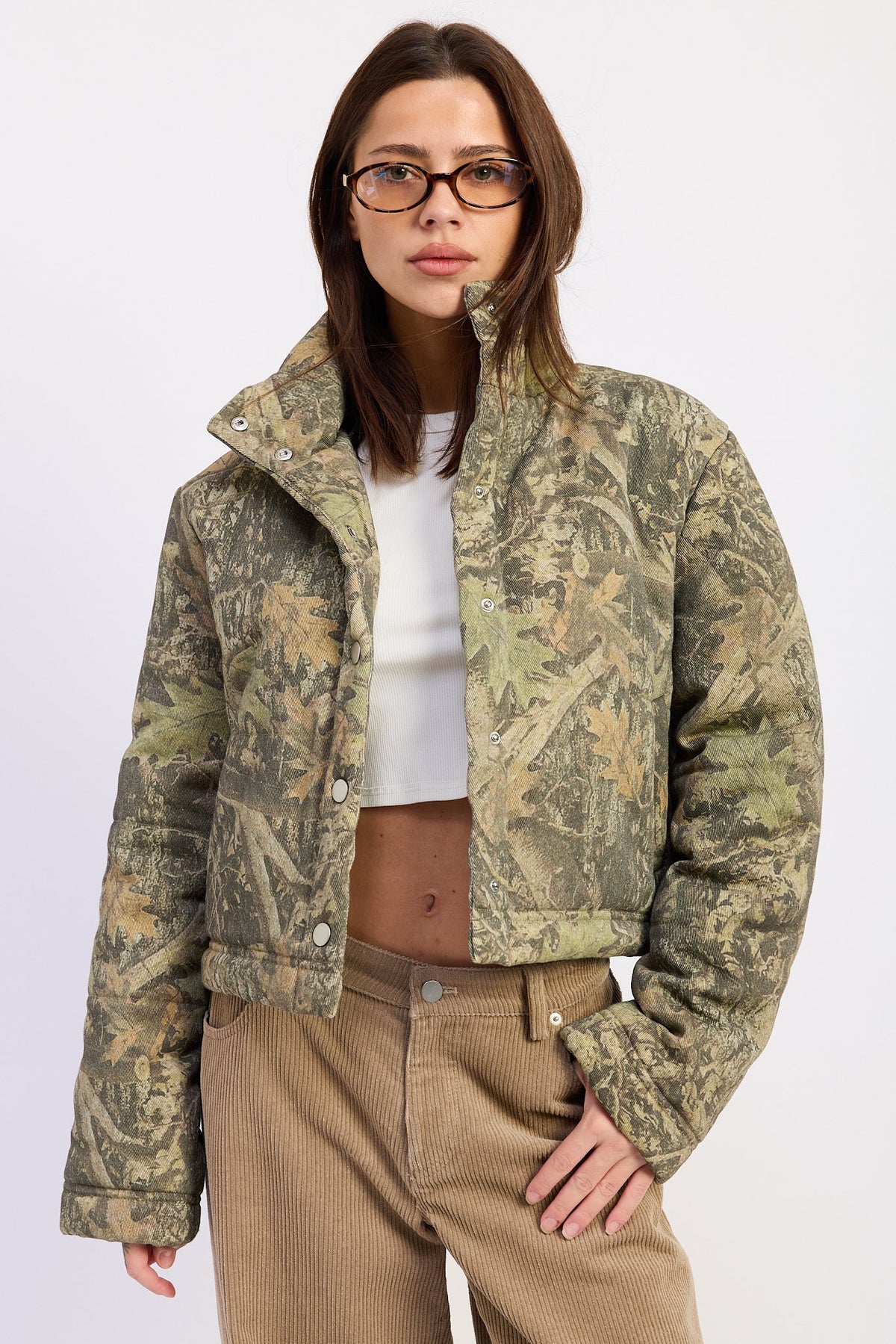 Olive green Dinara puffer jacket by Emory Park, insulated, with a high collar and quilted design, suitable for cold weather.