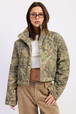 Olive green Dinara puffer jacket by Emory Park, insulated, with a high collar and quilted design, suitable for cold weather.