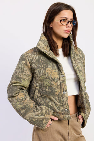 Olive green Dinara Puffer Jacket by Emory Park, displayed on a hanger with a quilted, insulated design perfect for cold weather.