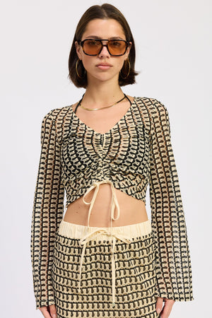 Cream and black Daleyza top by Emory Park, featuring a stylish design, displayed on a neutral background.