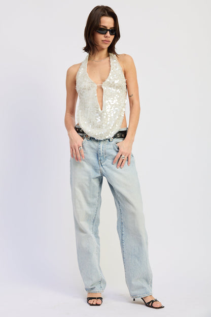 Off-white Tatiana halter top by Emory Park, stylish sleeveless design with a halter neckline, shown on a model.