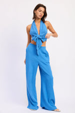 Emory Park Jadae halter neck top in ocean blue, sleeveless design with a fitted silhouette, shown on a model.