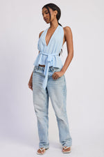 Emory Park Eirene halter top in baby blue with a fitted design and tie straps, displayed on a hanger.