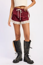 Emory Park Claire Shorts in burgundy, casual denim shorts with a relaxed fit, front and back pockets, on a plain background.