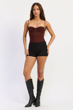Emory Park Lillian Bodysuit in cayenne red, a stylish sleeveless top with a fitted design and smooth fabric.