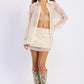 Ivory Starling Mini Skirt by Emory Park, stylish high-waisted skirt with a fitted silhouette and subtle stitching details.