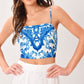 Flying Tomato Coastal Mosaic woven crop top in blue and white with a floral mosaic pattern, sleeveless design, and adjustable straps.